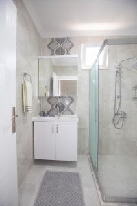 a bathroom with a white sink and a shower at Villa Cennet Dalaman 11 in Dalaman