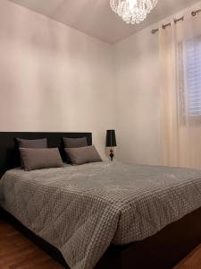 a bedroom with a bed and a chandelier at Casa de Sergude in Peso da Régua