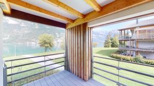 an open balcony with a view of the water at Walensee House & Apartments in Unterterzen