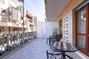a balcony with a table and chairs on a building at Prezioso suites & rooms in Lecce