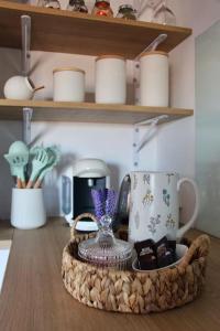 a tray with a coffee maker and cups on a shelf at El Adarve de la Inolda in Toledo