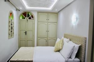 a bedroom with a bed and a couch at DAR Riad Jomana in Marrakech