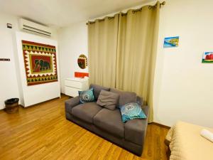a living room with a couch in a room at Marco Polo Party Hostel in St. Julianʼs