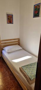 A bed or beds in a room at Casa Stazione Magliana