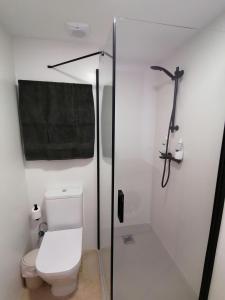 a white bathroom with a toilet and a shower at Piso pl 2A, 20 min Plaza Cataluña in Sant Adria de Besos