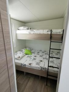 a small room with two bunk beds in it at Mediterranean mobile homes - Lotty in Drage