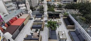 an overhead view of a rooftop patio with tables and chairs at Marco Polo Party Hostel in St. Julianʼs