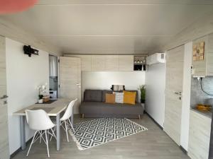 a small room with a bed and a table and chairs at Mediterranean mobile homes - Lotty in Drage +23 photos