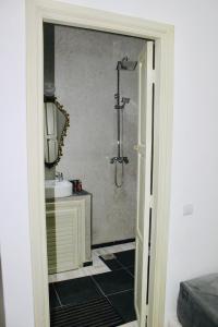 a bathroom with a shower and a sink at DAR Riad Jomana in Marrakech