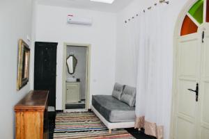 a living room with a couch and a door at DAR Riad Jomana in Marrakech