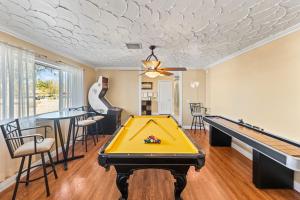 a living room with a pool table and ping pong ball at Spacious Desert Getaway! 1-Story, 5BR, 3 Master Suites, Casita, Pool, EV, Game Room in Las Vegas