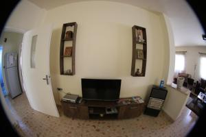 a view of a living room with a flat screen tv at Alice & Andrew Apt. Few Steps to Madaba Old City Center in Madaba