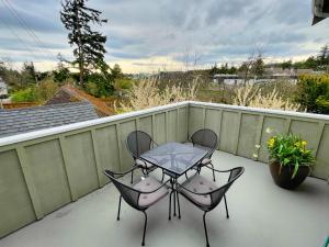 a patio with two chairs and a table on a balcony at Friday Harbor Grand in Friday Harbor