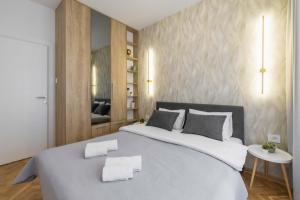 1 dormitorio con 1 cama grande y 2 toallas. en Apartment Marina, en Novi Sad