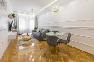 a living room with a couch and a table at Apartment Marina in Novi Sad
