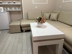 a living room with a couch and a white coffee table at SUN TOWER-CENTER of TIRANA in Tirana
