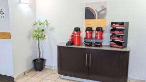 a counter with a red fire extinguisher on it at Motel 6-Framingham, MA - Boston West in Framingham