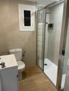 a bathroom with a shower and a toilet and a sink at Beta's Beach in Blanes