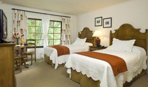 Cama ou camas em um quarto em Hotel Posada Los Alamos
