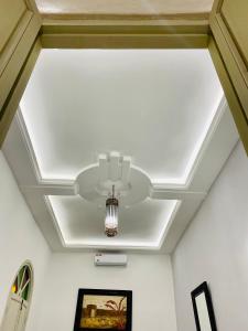 a ceiling with a light and a chandelier at DAR Riad Jomana in Marrakech