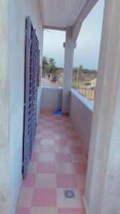 a balcony with a pink and white tile floor at Emefa Room in Cotonou