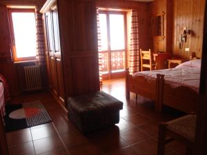 Ένα ή περισσότερα κρεβάτια σε δωμάτιο στο Hotel Alpe Fleurie