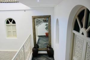 a hallway with a mirror on the wall at DAR Riad Jomana in Marrakech