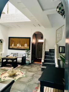 a living room with a couch and a table at DAR Riad Jomana in Marrakech
