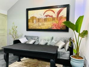 a living room with a couch and a painting on the wall at DAR Riad Jomana in Marrakech