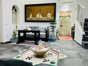 a living room with a couch and a table at DAR Riad Jomana in Marrakech