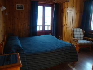 Ένα ή περισσότερα κρεβάτια σε δωμάτιο στο Hotel Alpe Fleurie