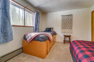 a bedroom with a bed and a window at Graeagle Vacation Rental Cabin with Game Room! in Graeagle