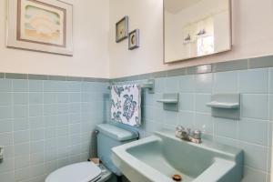 a blue bathroom with a toilet and a sink at 4 Mi to Beaches Pet-Friendly Berlin Home! in Berlin +19 photos