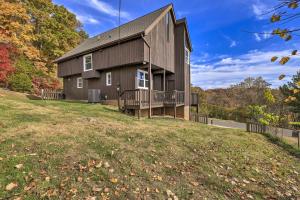a house on top of a grassy hill at Deck and Mtn Views Fain Chalet in Kingsport in Kingsport