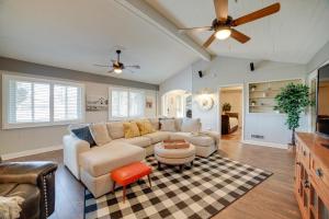 a living room with a couch and a ceiling fan at Broadmoor Getaway with Pickleball Court! in Colorado Springs