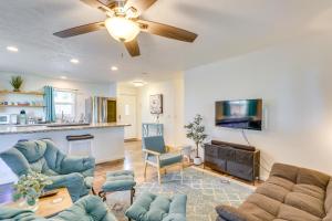 a living room with blue furniture and a ceiling fan at 2 Mi to Town and Beach! Lovely Kailua-Kona Home in Kailua-Kona