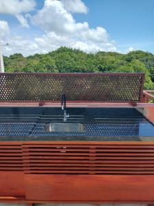 a kitchen with a sink on the roof of a house at Flat com Terraço Pipa Beleza Resort in Pipa +33 photos