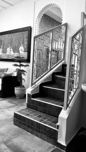 a staircase with a gate and a potted plant at DAR Riad Jomana in Marrakech