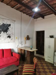 a living room with a red couch and a table at Doña Isabel 2 in Gualeguay