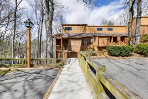 a wooden house with a fence and a driveway at Stunning Sapphire Valley Resort Townhome with Perks! in Sapphire