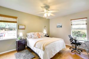 a bedroom with a bed and a desk and a ceiling fan at Pet-Friendly San Diego Home with Patio! in San Diego