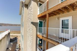 a balcony of a house with a view of the water at Lakefront Ozark Condo with Spacious Balcony! in Camdenton