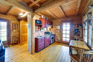a kitchen with wooden walls and wooden floors in a cabin at Blue Sky Cabin in Sequim with Private Hot Tub! in Sequim
