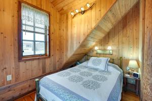 a bedroom with a bed in a wooden cabin at Blue Sky Cabin in Sequim with Private Hot Tub! in Sequim