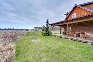 a wooden house with a deck and a yard at Blue Sky Cabin in Sequim with Private Hot Tub! in Sequim