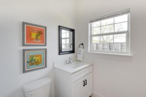 a white bathroom with a sink and a window at Pet-Friendly Bowie Studio with Deck! in Bowie +21 photos
