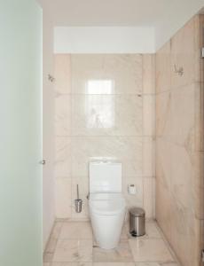 a bathroom with a white toilet in a room at Luzeiros Suites in Lisbon