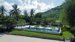 an image of a swimming pool in a resort at The Suites Lombok in Sekotong