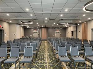 a room with rows of chairs in a hall at Holiday Inn Cleveland-Mayfield, an IHG Hotel in Mayfield