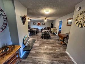 a living room with a clock on the wall at Sunny Shuswap B&B in Chase